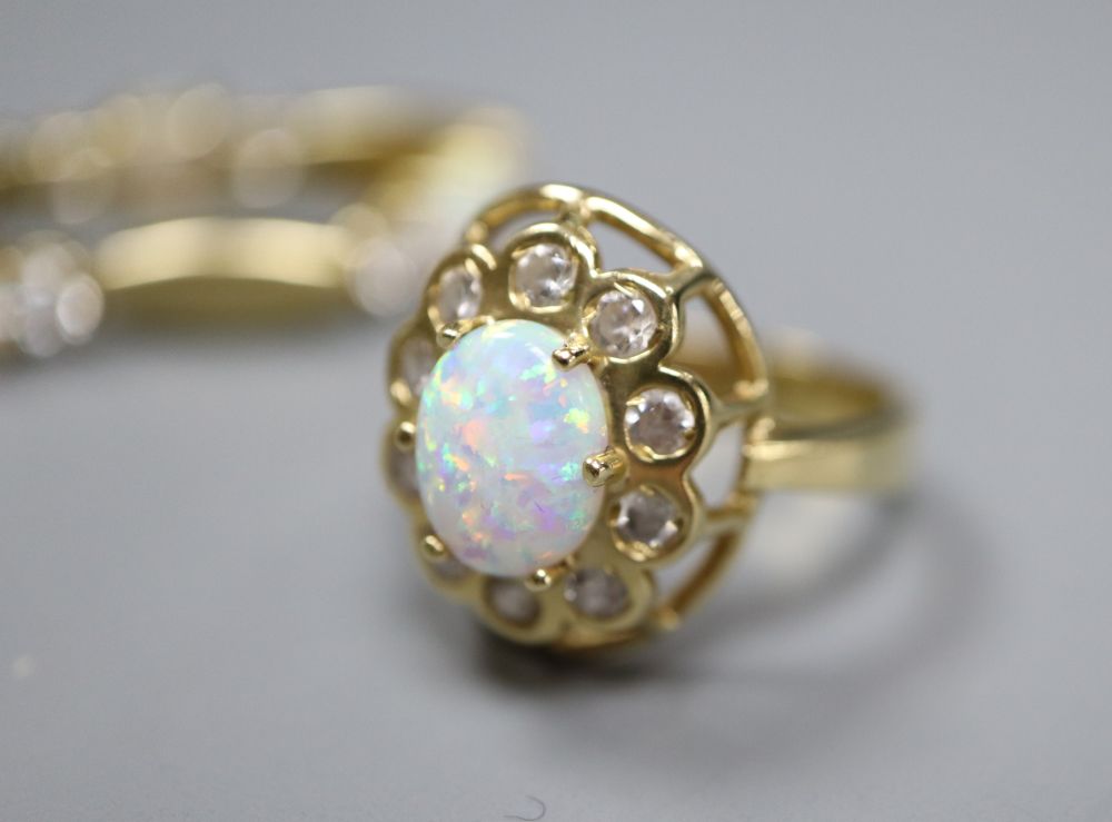 A pair of 585, white opal and paste stud earrings and a similar paste-set bracelet and ring ensuite, gross 21.6g.